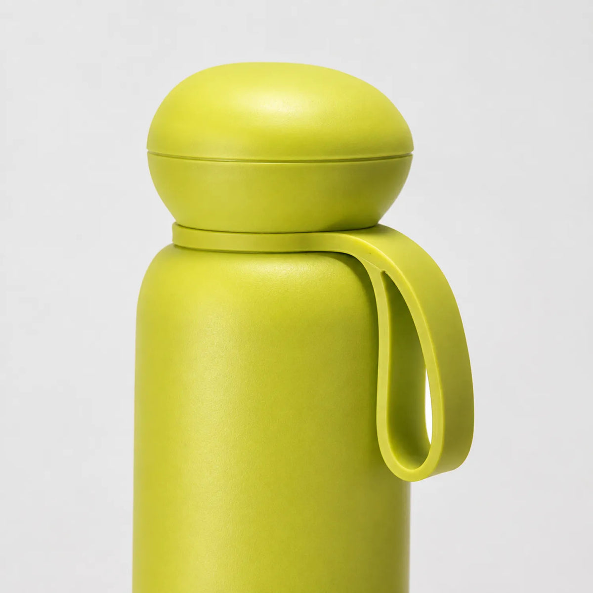 Yellow-green drink bottle standing upright with a rounded dome cap and a short loop strap.