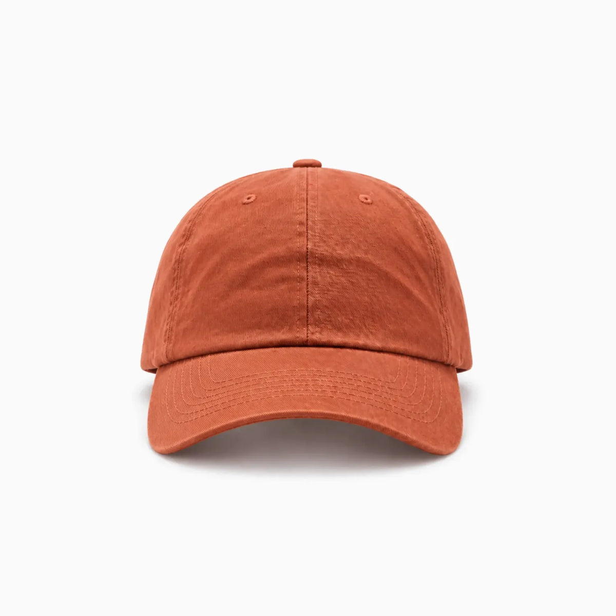 A classic six-panel dad hat in a burnt orange colour, shown from a front view angle on a clean background.