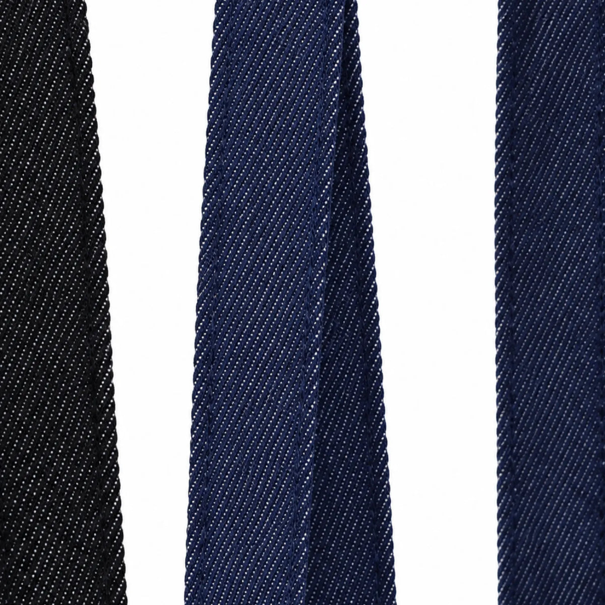 Close-up of the denim-look twill handle straps on the wide gusset tote bag in black and indigo, showing the fine diagonal weave and stitched edges