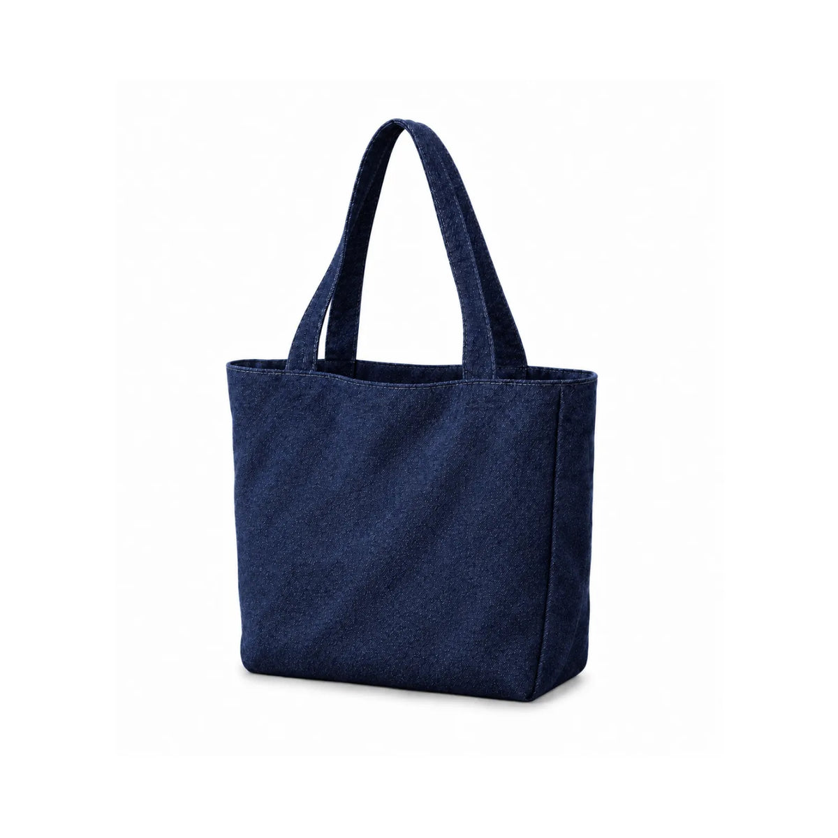 An indigo denim fabric tote bag presenting natural three-quarter angle in a white background.