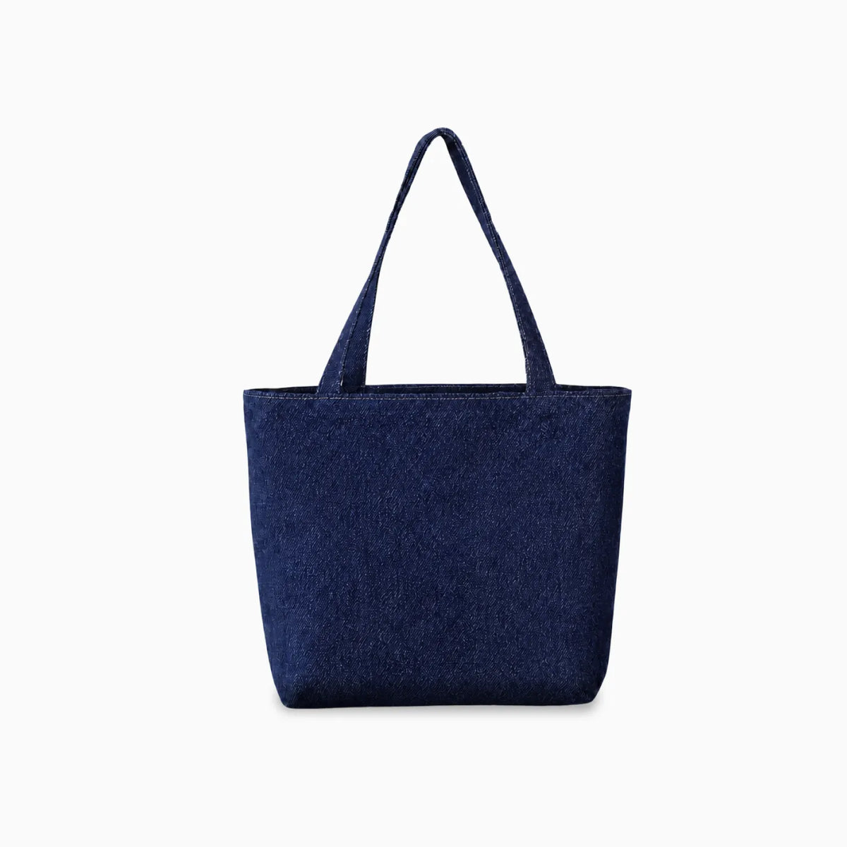 A dark indigo denim fabric tote bag with two shoulder straps, shown against a plain light grey background.