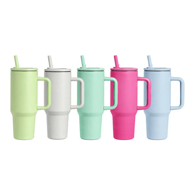 Five handled insulated tumblers with straws in pastel shades of pistachio green, white, mint green, hot pink, and soft blue, arranged in a row on a white background.