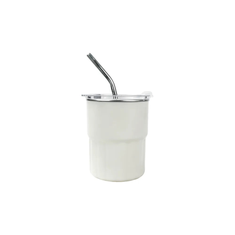 White iced coffee tumbler with a metal straw on a white background