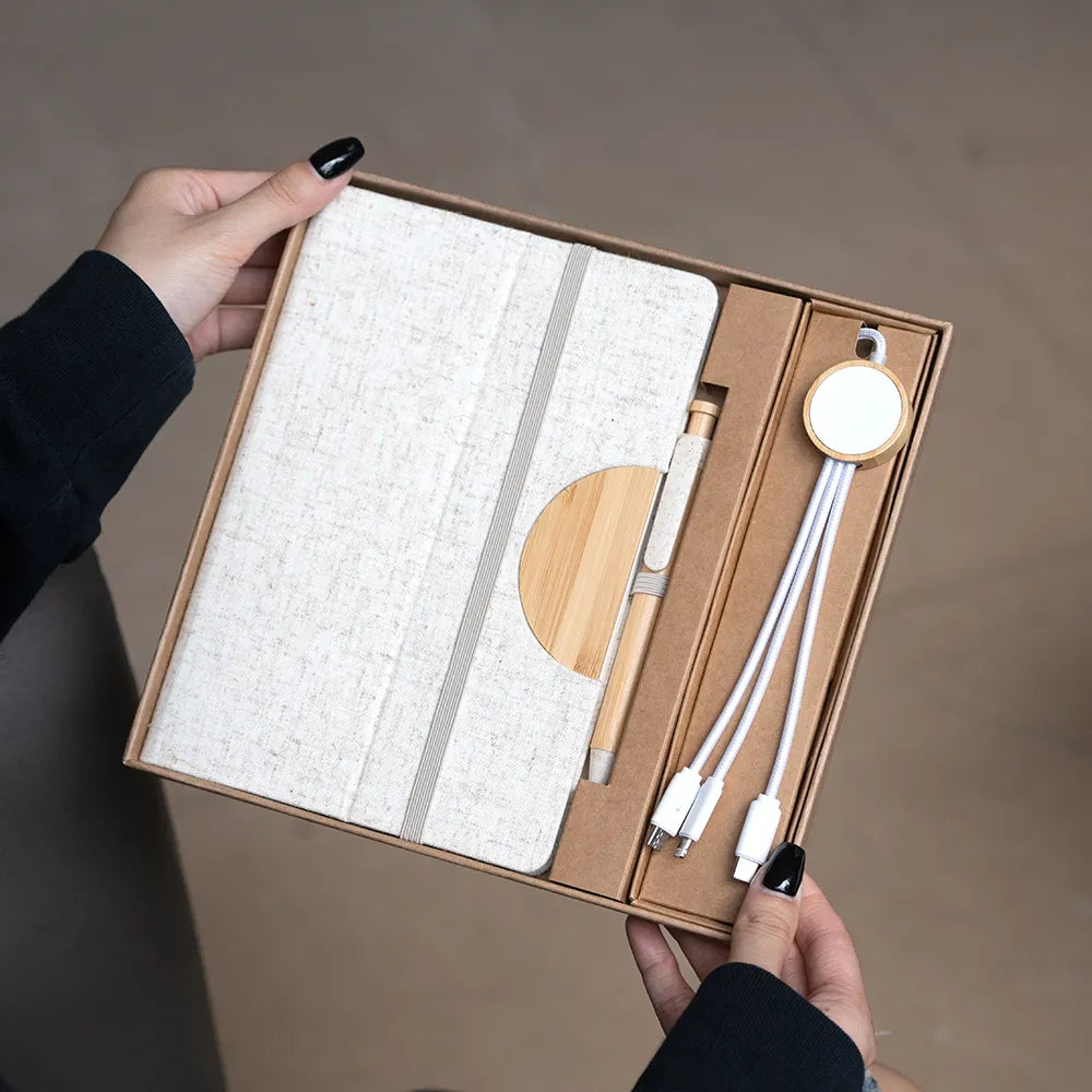 A5 bamboo notebook and 3-in-1 charging cable desk kit in kraft gift box, green elastic and pen colourway, viewed at three-quarter angle