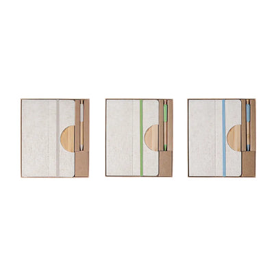 A5 cotton linen notebook and bamboo pen desk kit shown in three elastic band colour variants, natural, green and blue, in kraft gift boxes, viewed from above