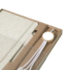 Close-up of A5 cotton-covered hardcover notebook with elastic closure and pen loop, natural cream textile texture