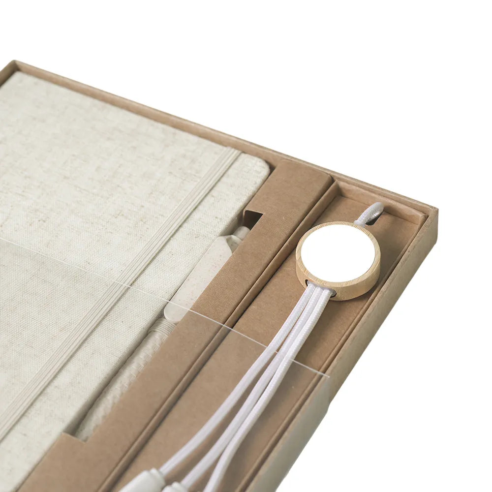 Close-up of A5 cotton-covered hardcover notebook with elastic closure and pen loop, natural cream textile texture