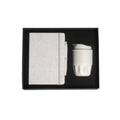 A5 cotton notebook and double-wall coffee cup welcome kit in black magnetic gift box with foam insert, viewed from above, natural colourway, no branding applied