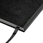 Back of the black A5 notebook on a white background showing the elastic band and pen loop, no Wumble branding applied