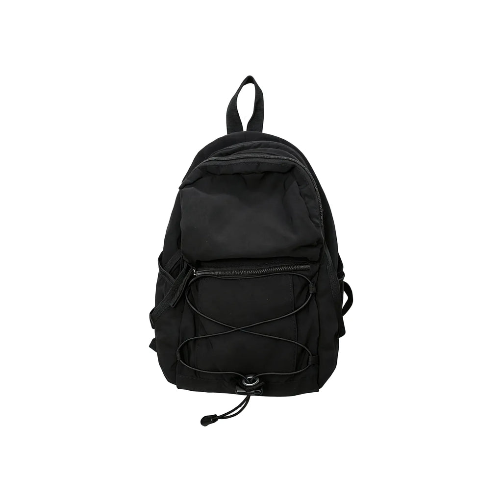 Black compact nylon outdoor daypack on a white background showing the front bungee cord, zip front pocket and twin shoulder straps, no Wumble branding applied