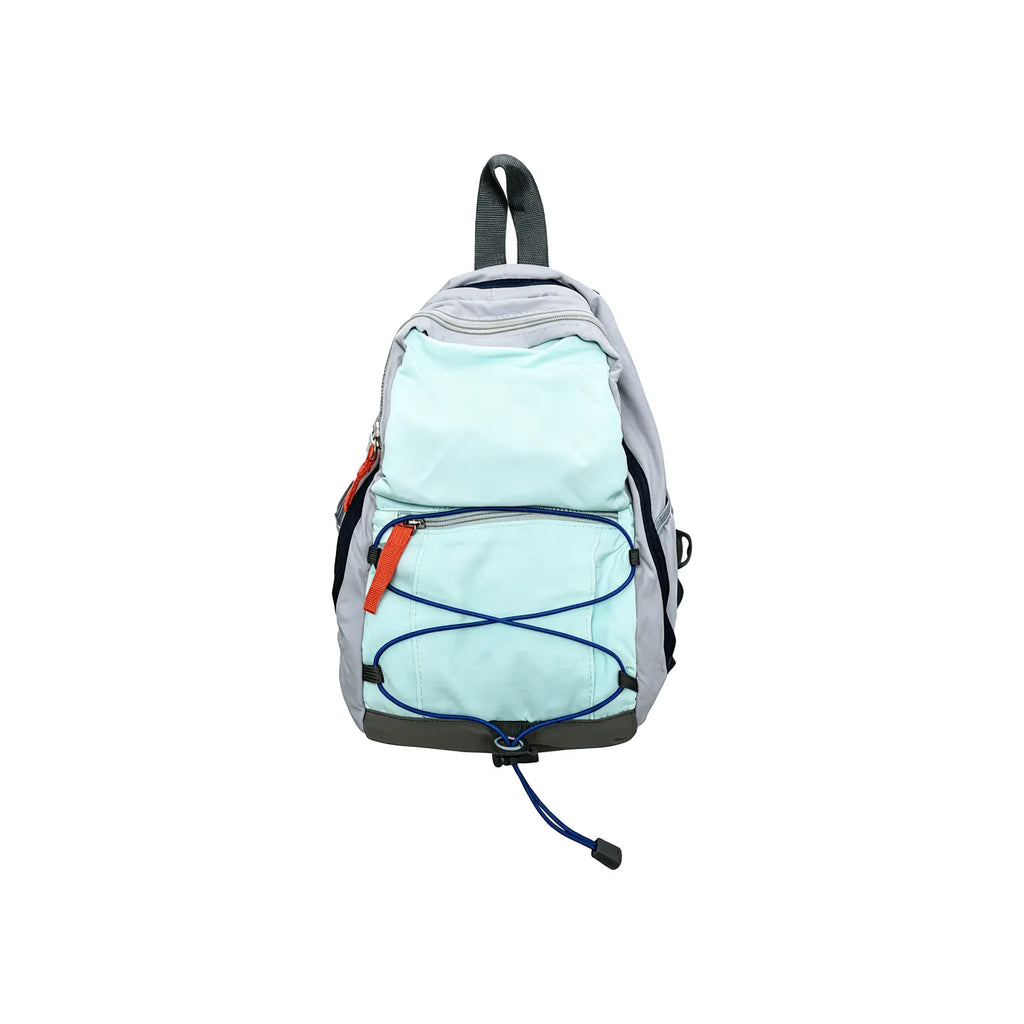 Mint blue compact nylon outdoor daypack on a white background showing the front bungee cord, zip front pocket and twin shoulder straps, no Wumble branding applied