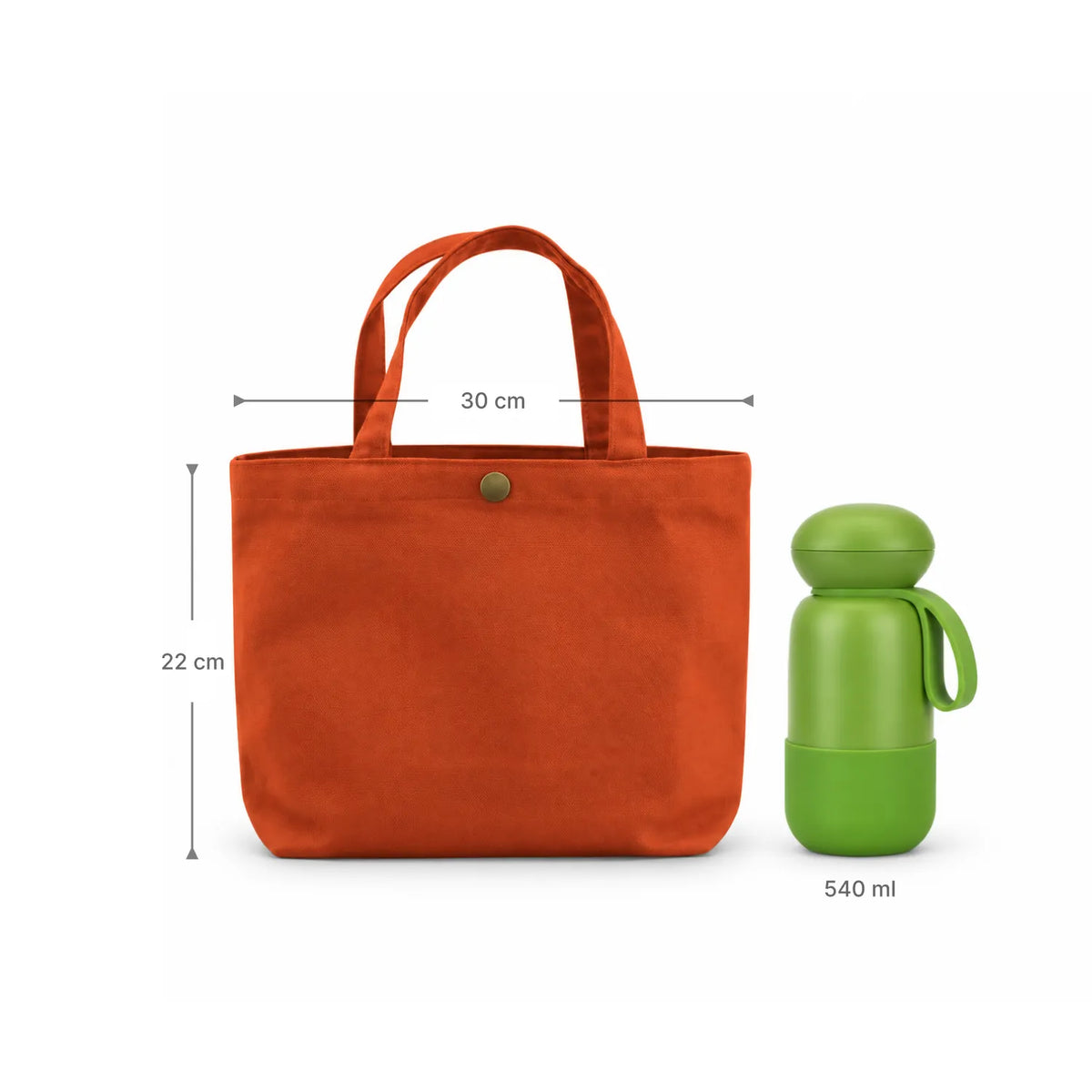 An clay orange canvas tote bag with two top handles and a small metal snap button,  in measurement sizes, 30cm for width and 22cm for length, shown next to a green 540 ml bottle on a white background.