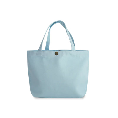 A soft blue gusseted canvas tote bag with dual shoulder straps and a small gold snap button closure at the top center, shown against a plain white background.