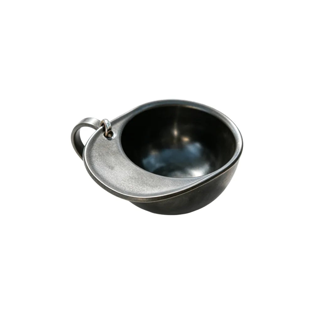 Black 60ml hat-shaped recycled coffee grounds tasting cup on a white background, top three-quarter view showing the hat-brim handle and lanyard ring, no branding applied
