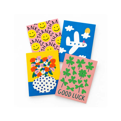Four illustrated greeting cards in Thanks, New Journey, Sunny Blooms and Good Luck designs, arranged on white