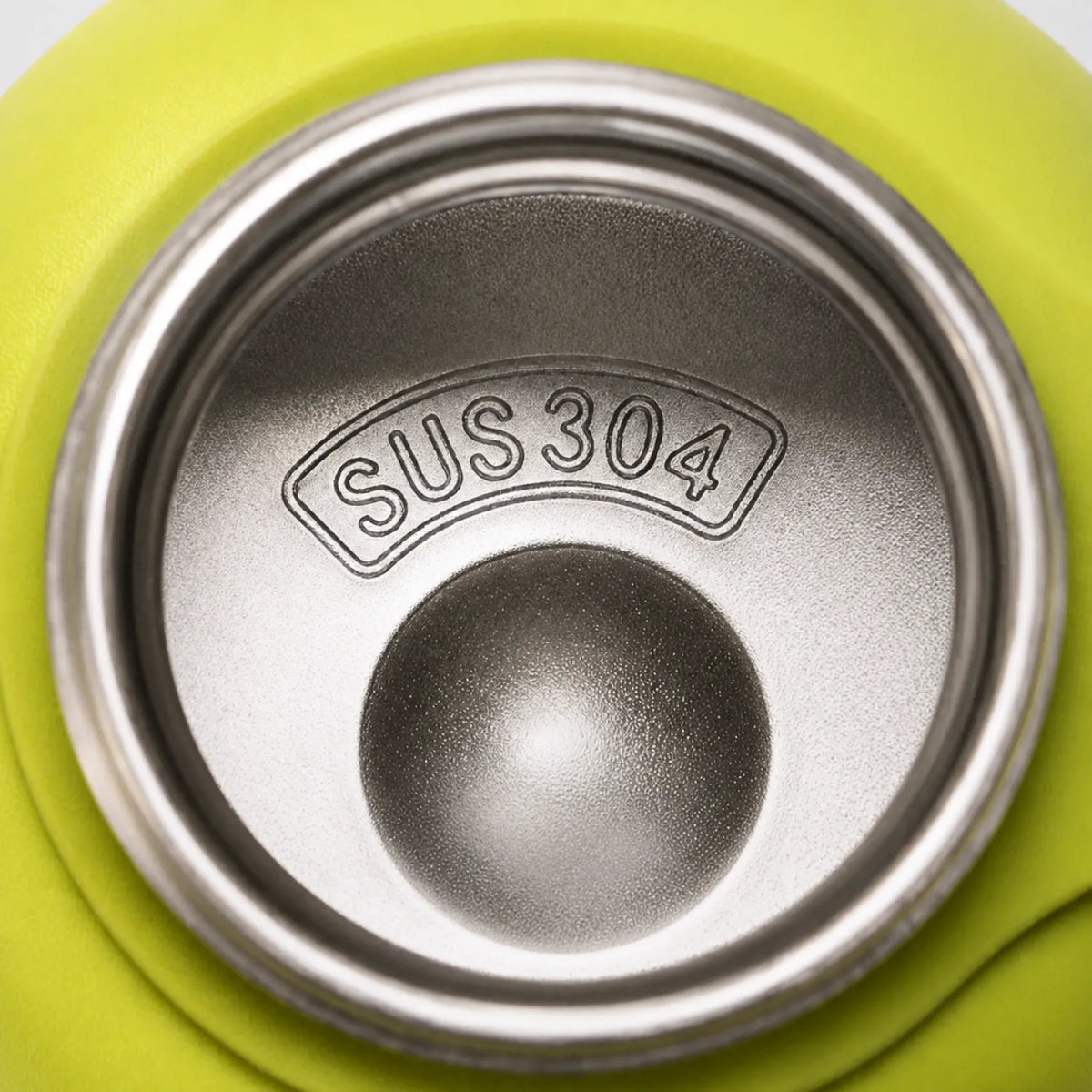 Top-down view into a yellow-green drink bottle, showing a polished interior with a raised centre dome.