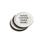 Round branded tin of recycled coffee grounds coasters with a sample smiley logo and "good coffee goes here" lid print, white background, gift packaging example