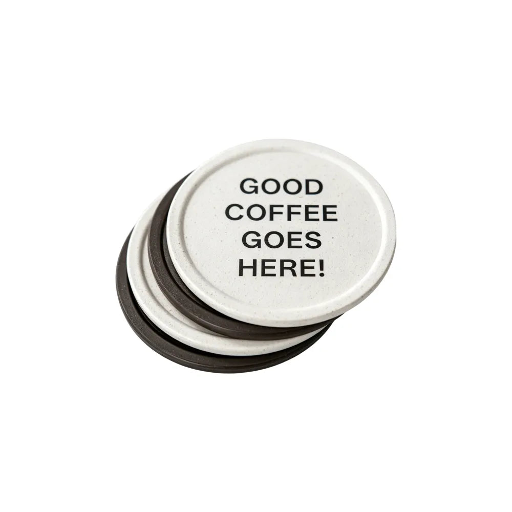 Round branded tin of recycled coffee grounds coasters with a sample smiley logo and "good coffee goes here" lid print, white background, gift packaging example