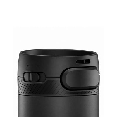 Close view of a black lid with a push button, a slide lock marked with padlock icons and a hatched grip band.