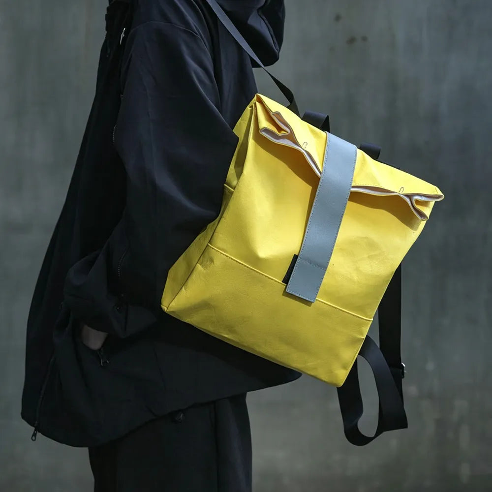 Person wearing custom branded Tyvek roll-top backpack, sustainable event merch by Wumble Merch Australia