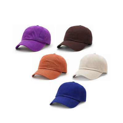 Five unstructured soft cotton dad caps in different colours (plum purple, dar brown, burnt orange, off white, and indigo blue) arranged on a plain white background.