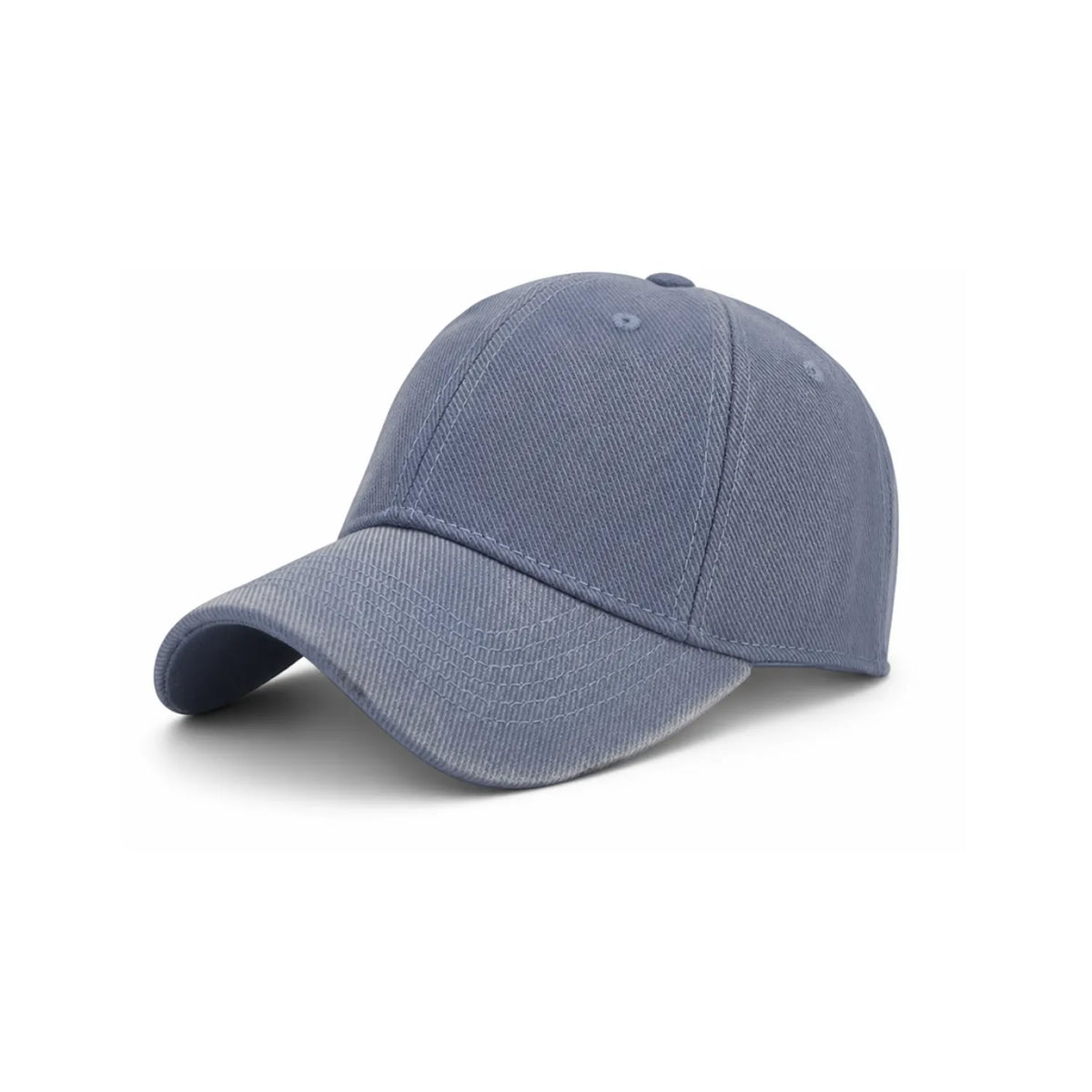 A classic six-panel cap in a washed, haze blue denim-like fabric, shown from a three-quarters angle on a white background.