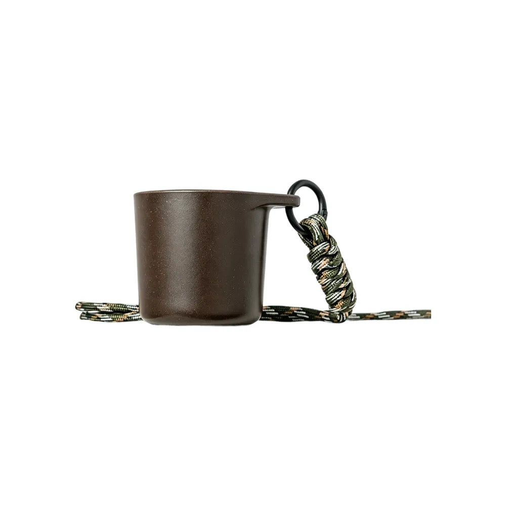 Dark brown water drop recycled coffee grounds tasting cup on a white background with a camouflage braided lanyard, speckled finish, no branding applied