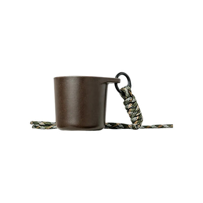 Dark brown water drop recycled coffee grounds tasting cup on a white background with a camouflage braided lanyard, speckled finish, no branding applied