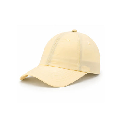 A light butter yellow waterproof lightweight nylon cap with a curved brim, photographed on a clean white background.