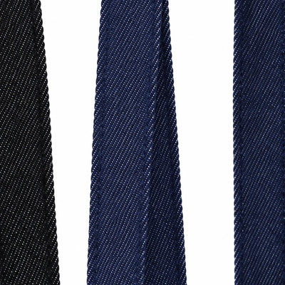 Close-up of the denim-look twill handle straps on the wide gusset tote bag in black and indigo, showing the fine diagonal weave and stitched edges