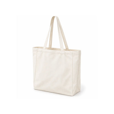 A plain canvas tote bag in a off-white at three-quarter angle, featuring two long shoulder straps, shown on a clean white background.