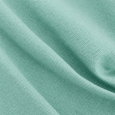 A close-up of soft teal green textured fabric with soft folds and a fine woven pattern.